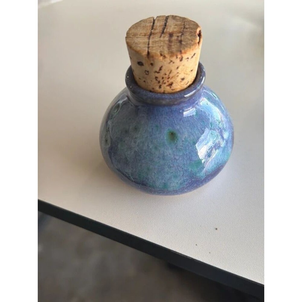 handcrafted crystalline glaze pottery jar fitted with a large cork stopper.